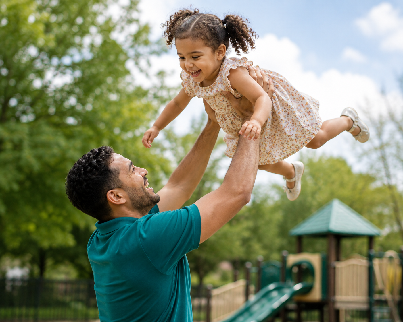 father holding daughter in air smiling
